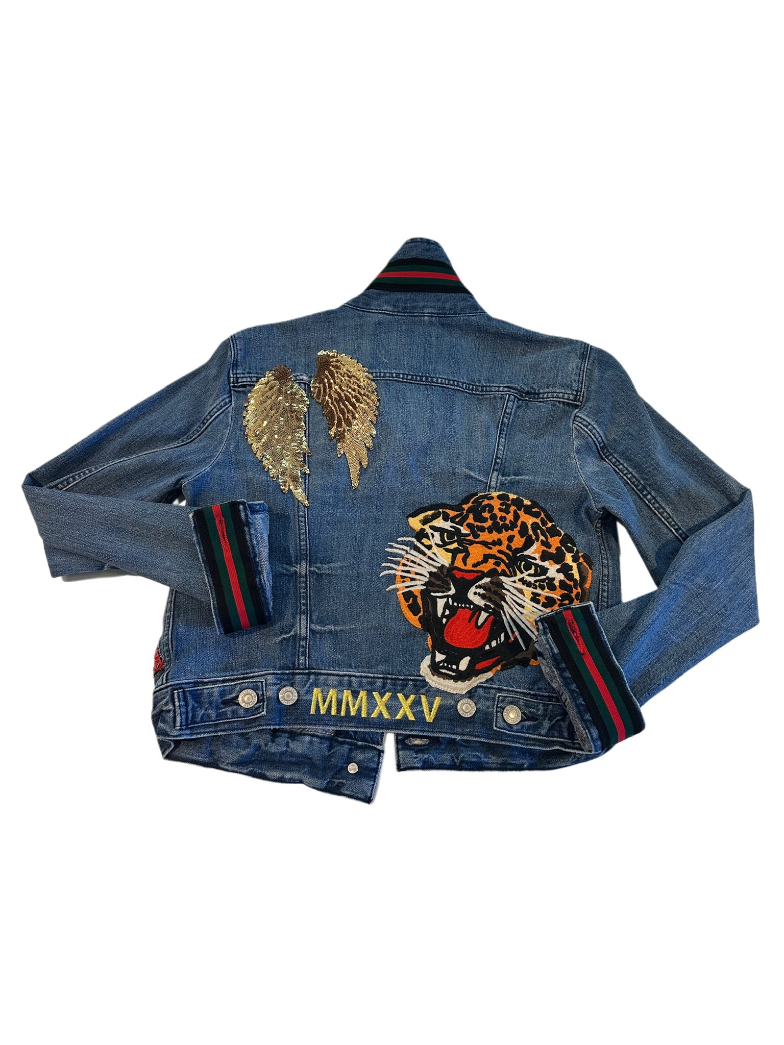Denim jacket with a leopard patch and 'MMXXV' branding on a white background