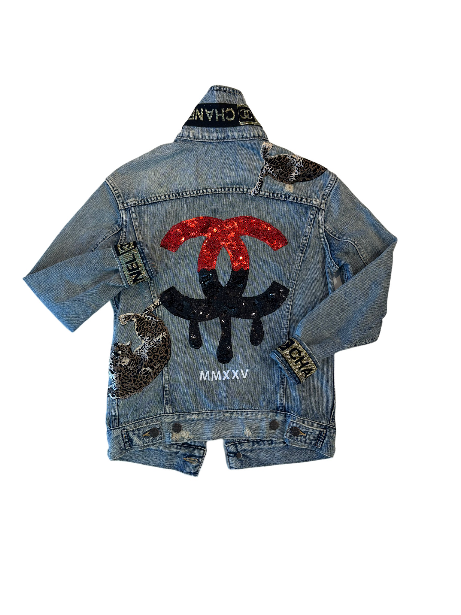 Blue denim jacket with colorful embellishments on a white background